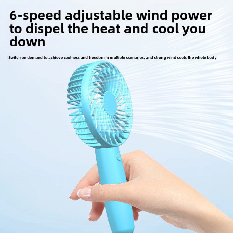 Handheld fan in use